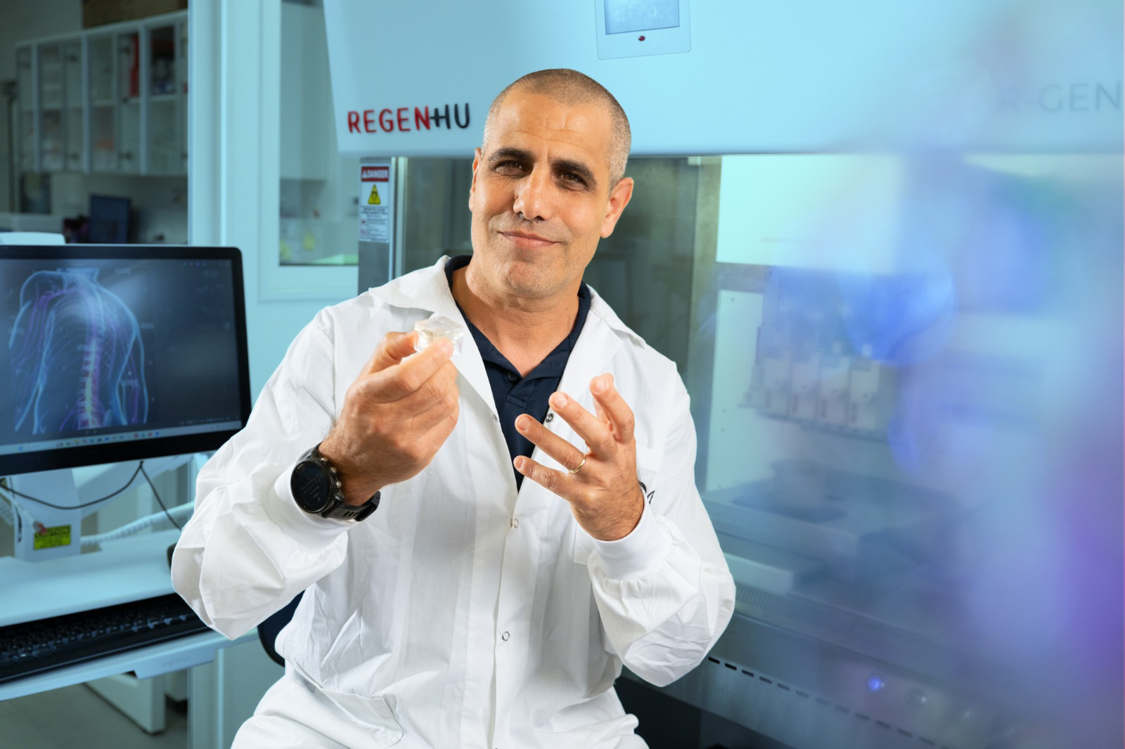 NVPX scientific founder in the laboratory holding an implant sample